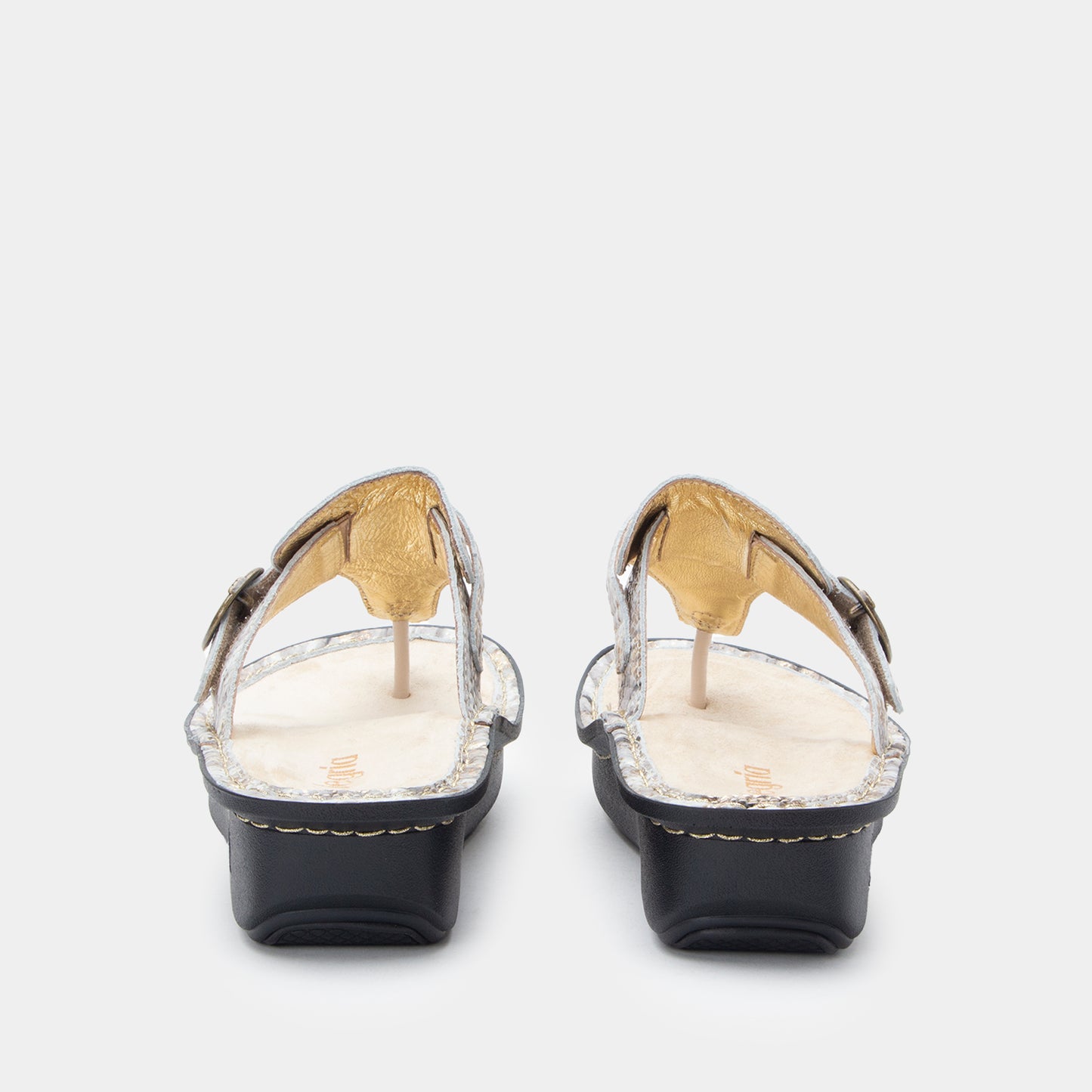 Pair of black sandals with gold accents on a white background
