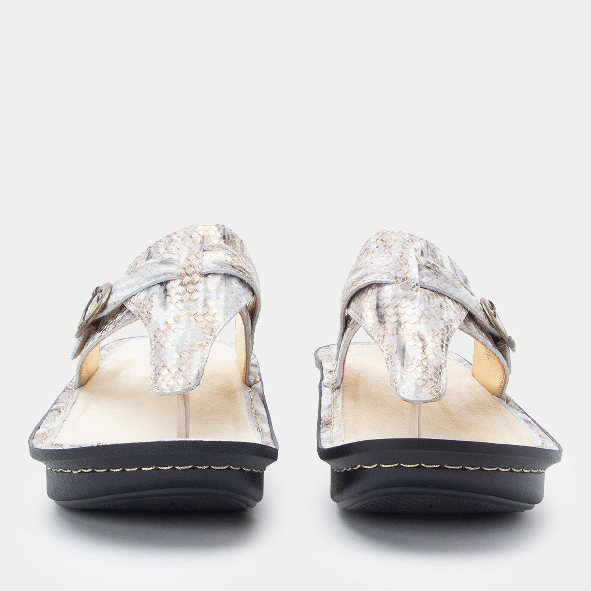 Pair of silver glittery sandals on a white background