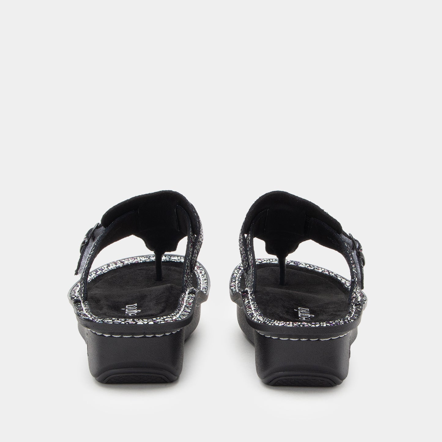 Black sandals with decorative straps on a white background
