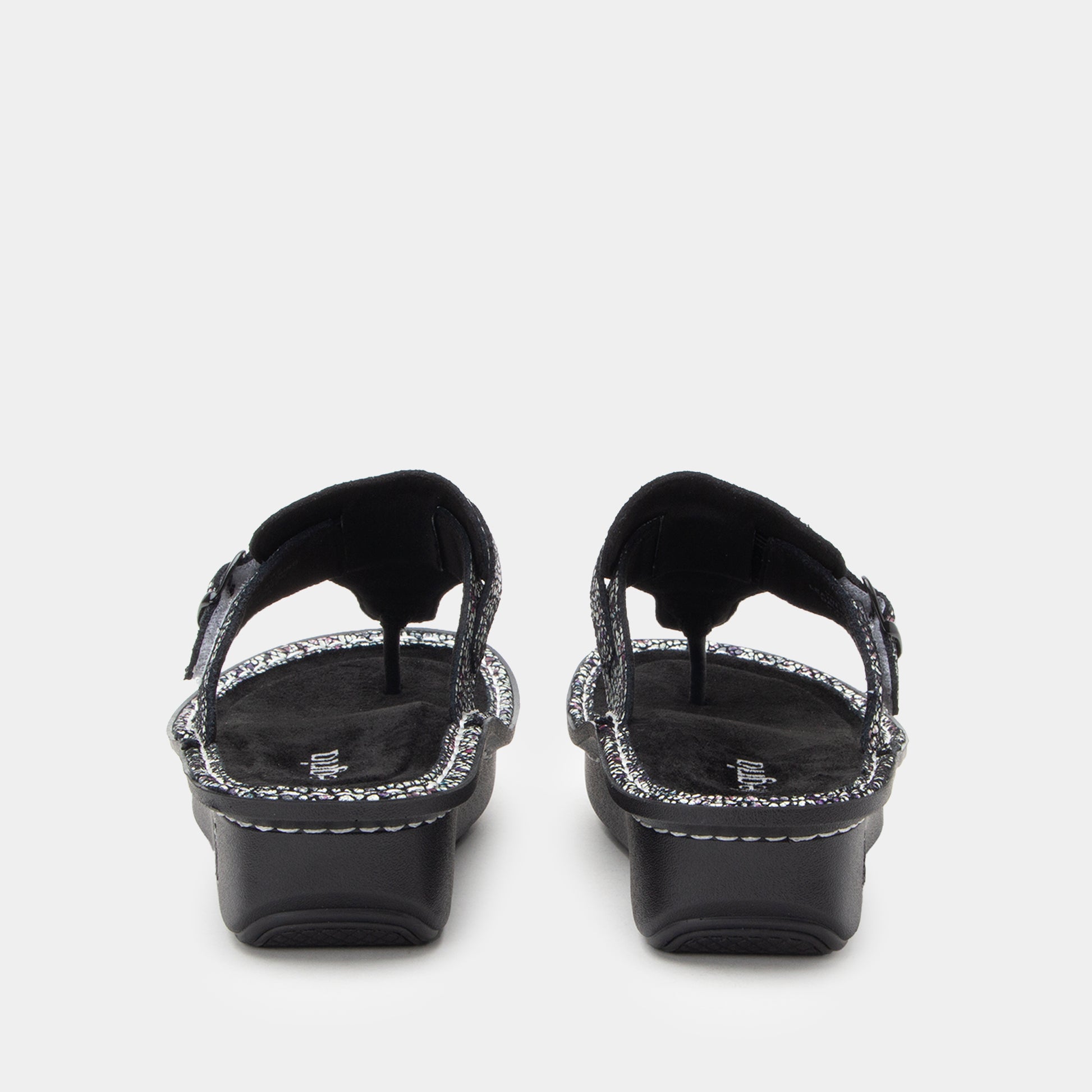 Black sandals with decorative straps on a white background