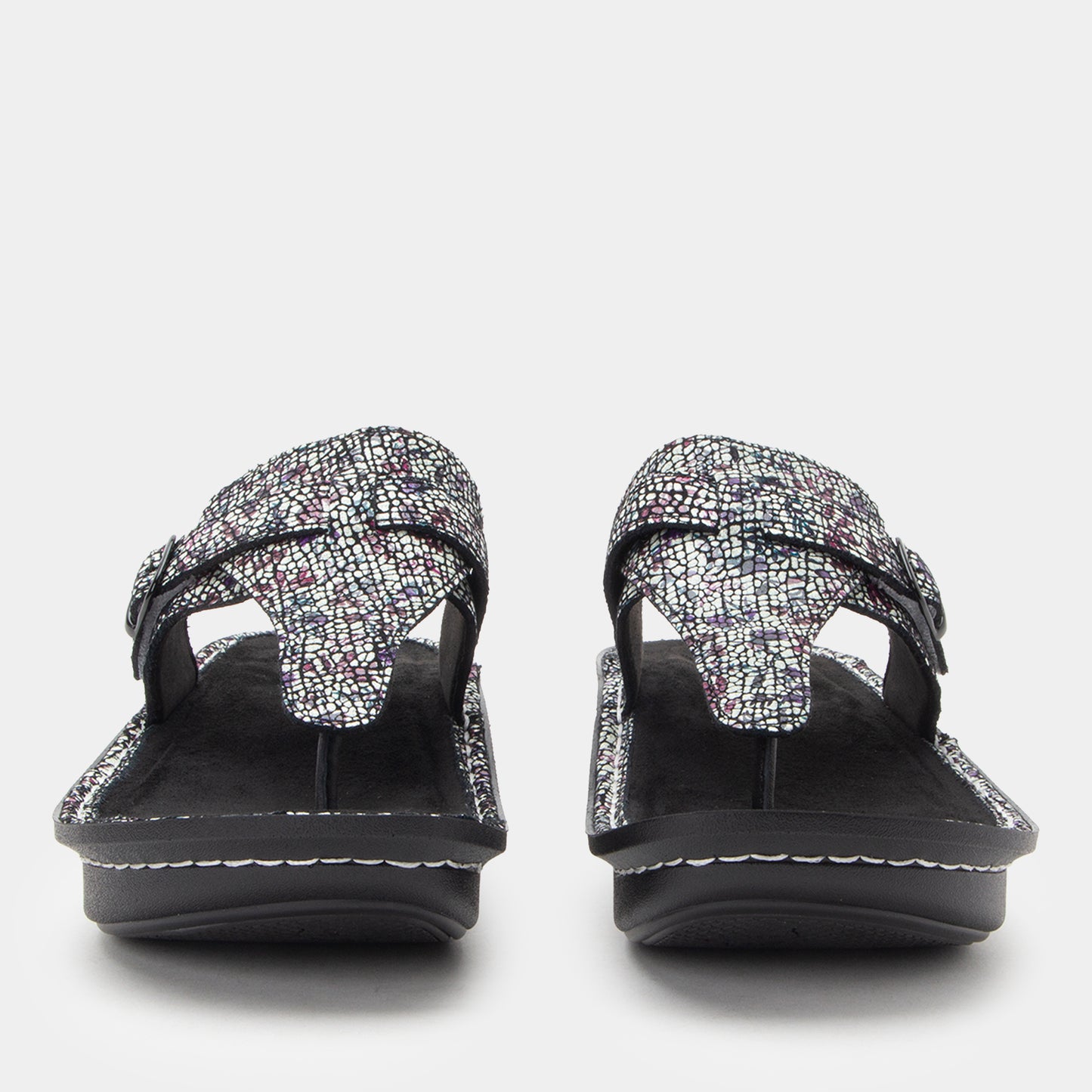 Pair of black sandals with textured straps on a white background