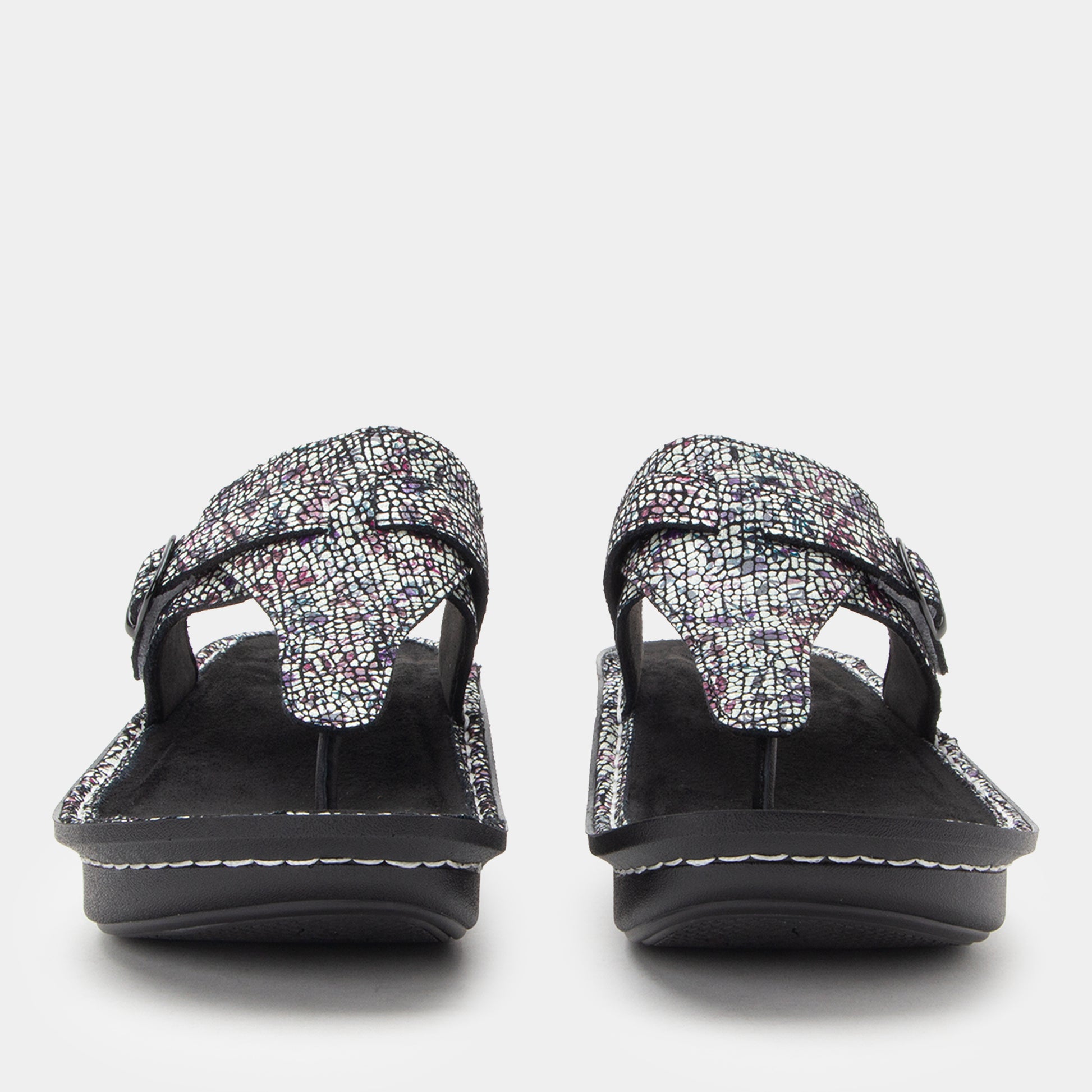 Pair of black sandals with textured straps on a white background