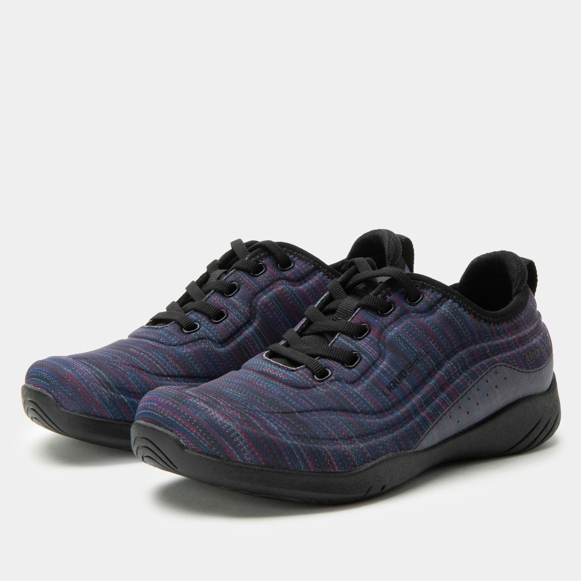 Pair of blue patterned sneakers with black soles on a light gray background