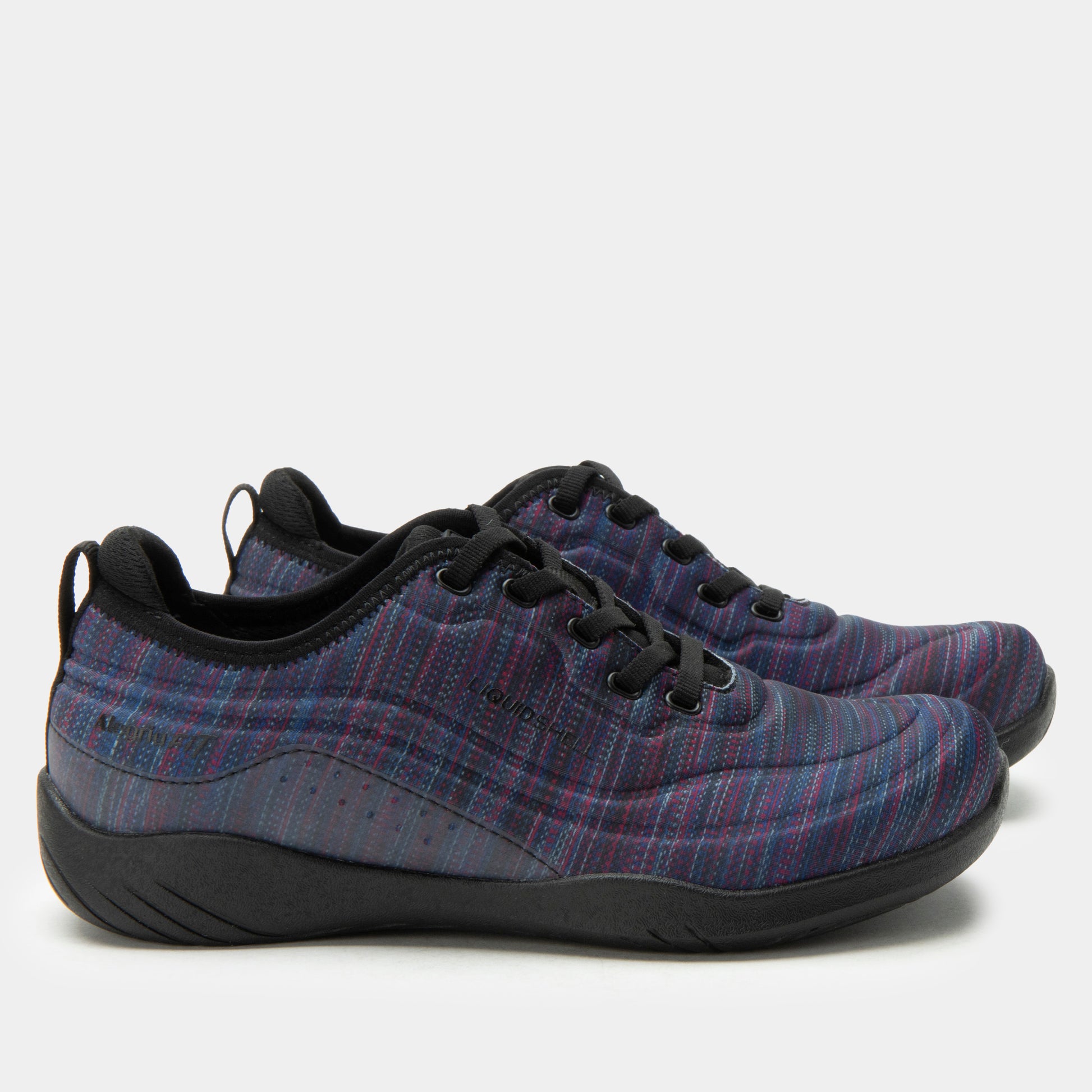 Pair of purple plaid sneakers with black soles on a white background