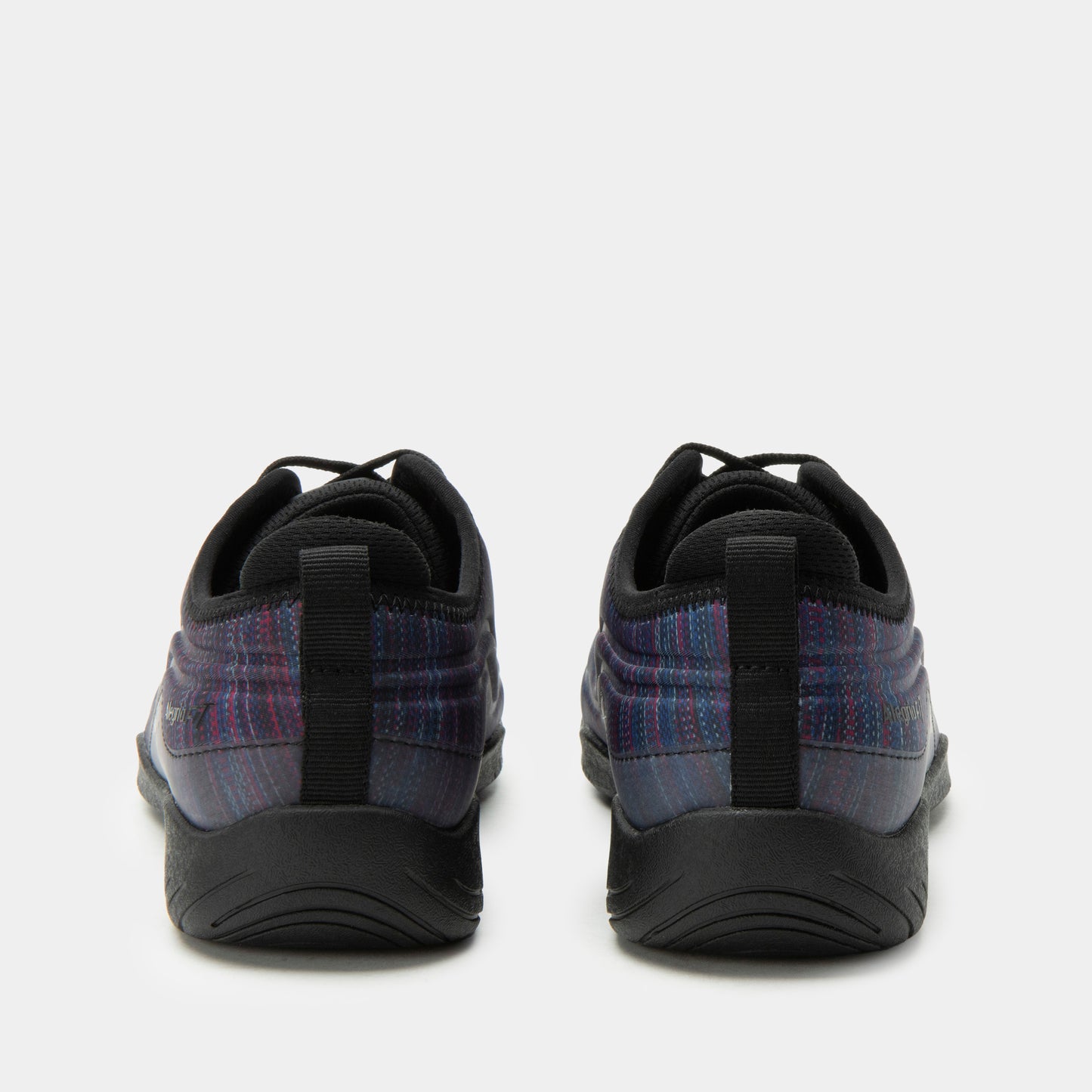 Black athletic shoes with plaid pattern on a white background