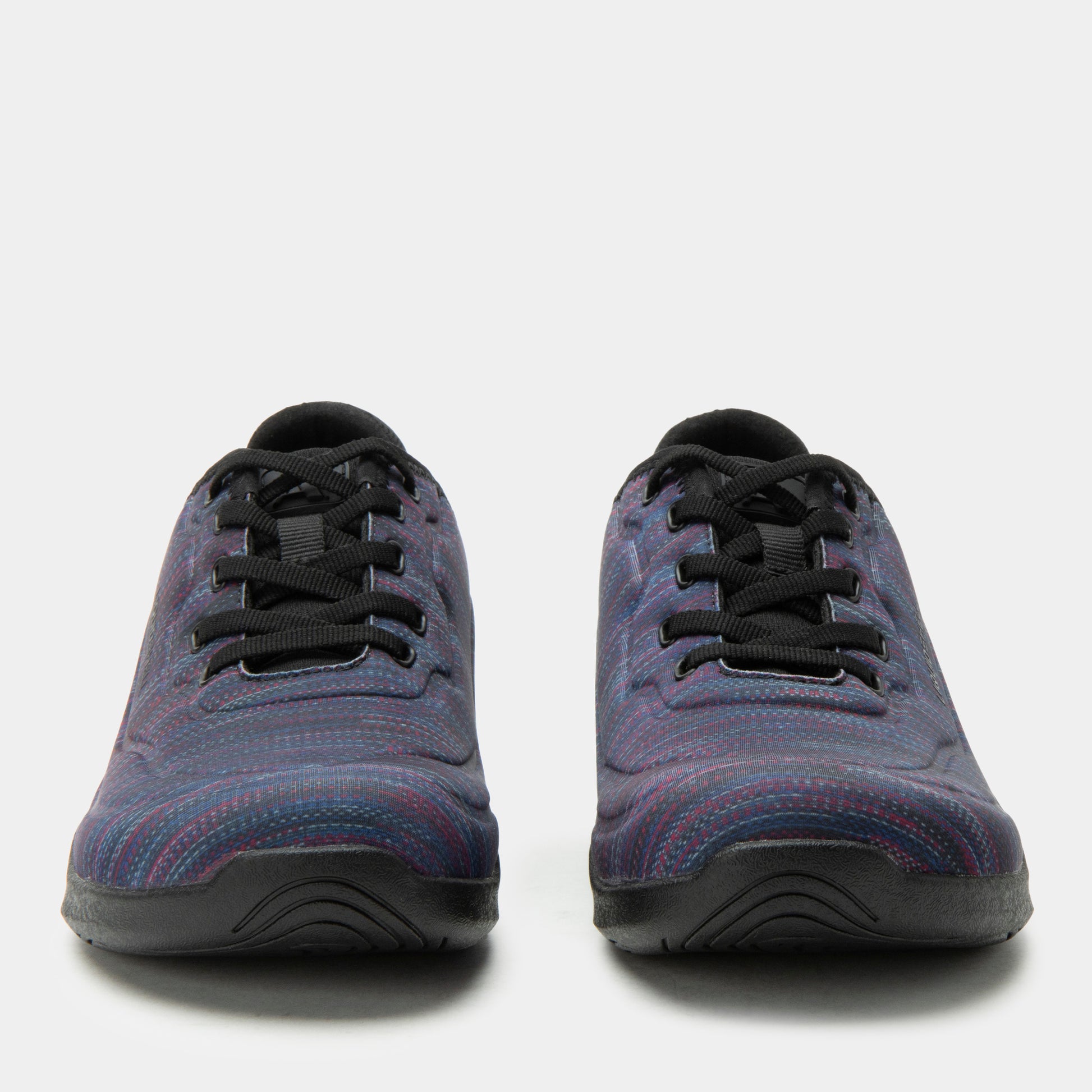 Pair of blue sneakers with black laces on a white background