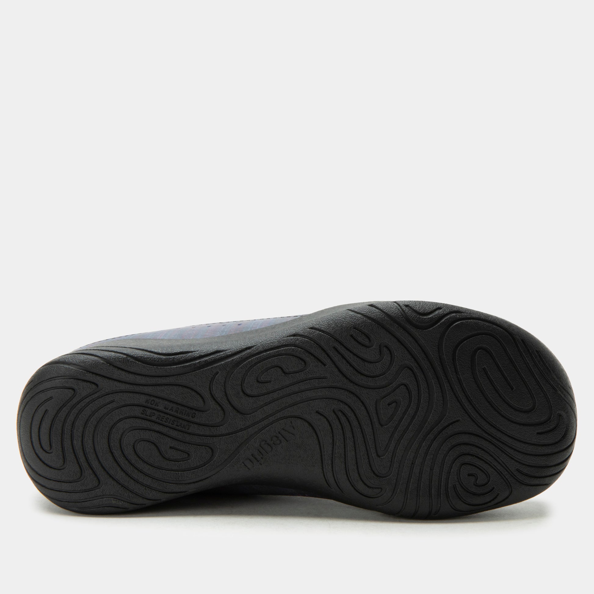 Black shoe sole with wavy tread pattern on a white background