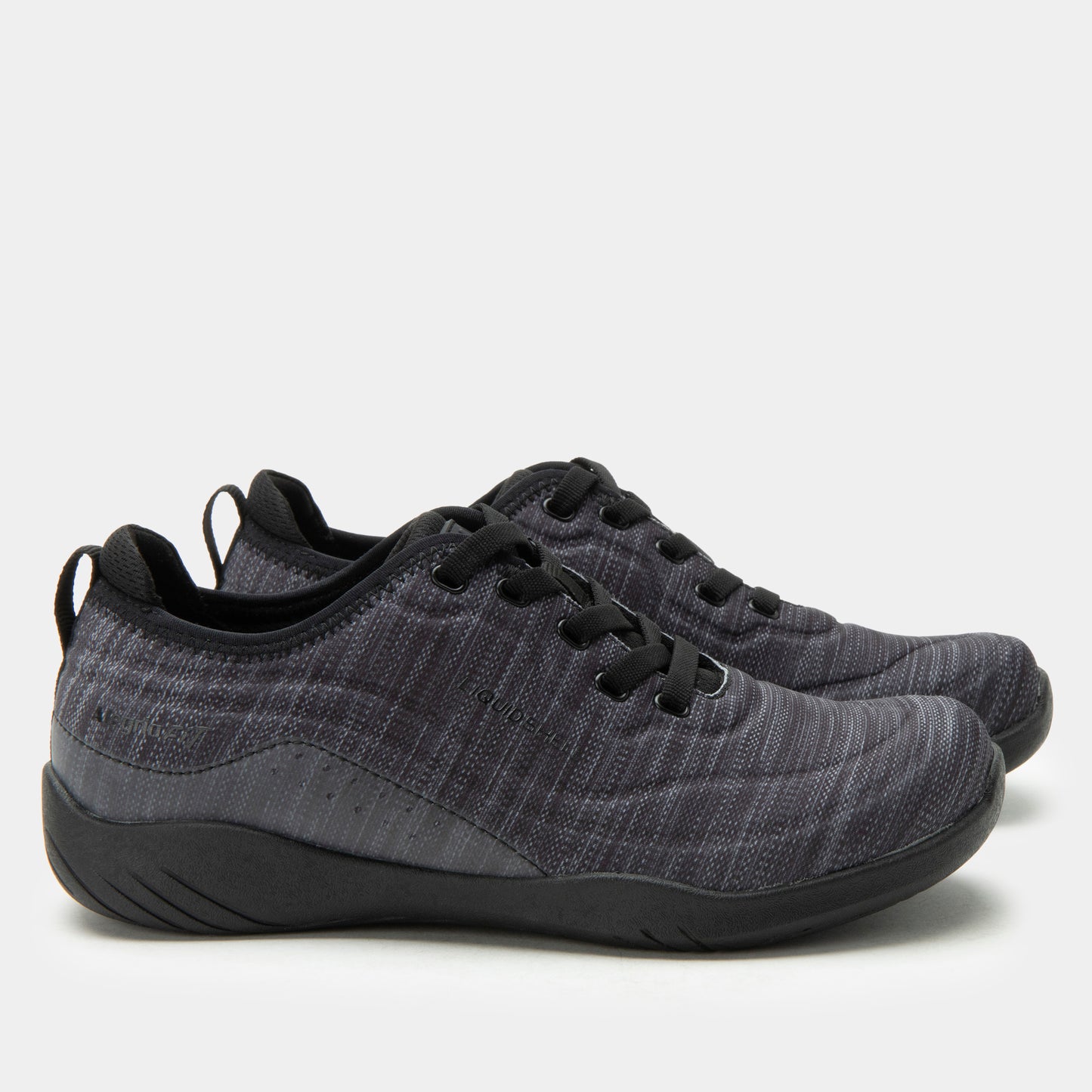 Pair of gray sneakers with black soles on a light gray background