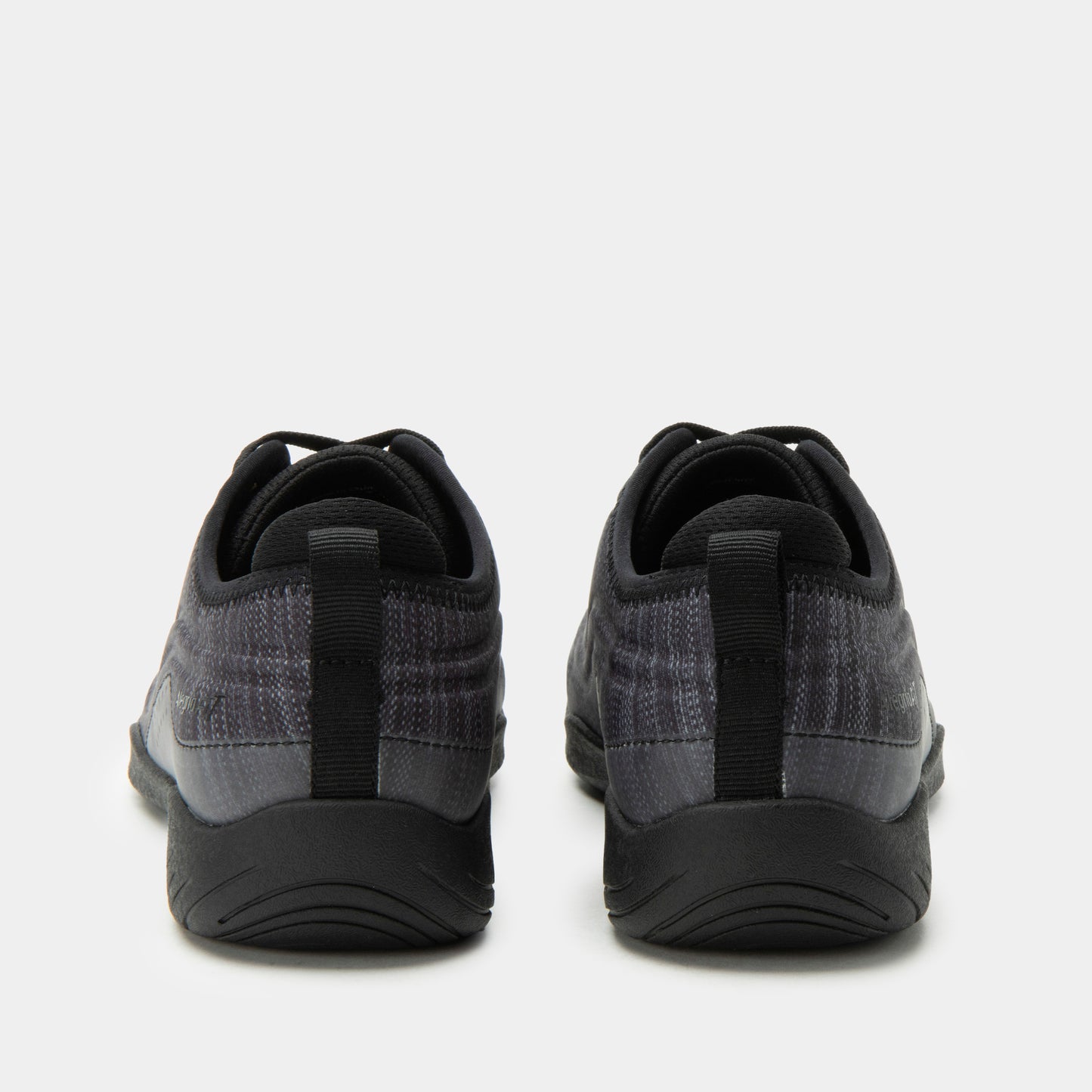 Black and gray athletic shoes on a white background