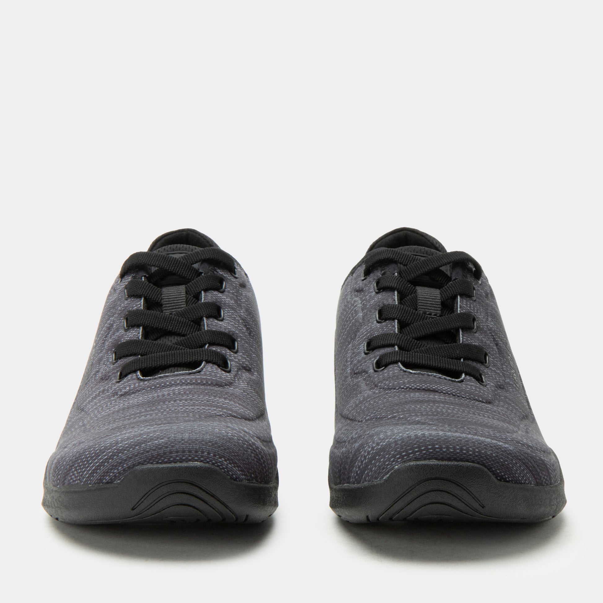 Pair of gray sneakers with black laces on a white background