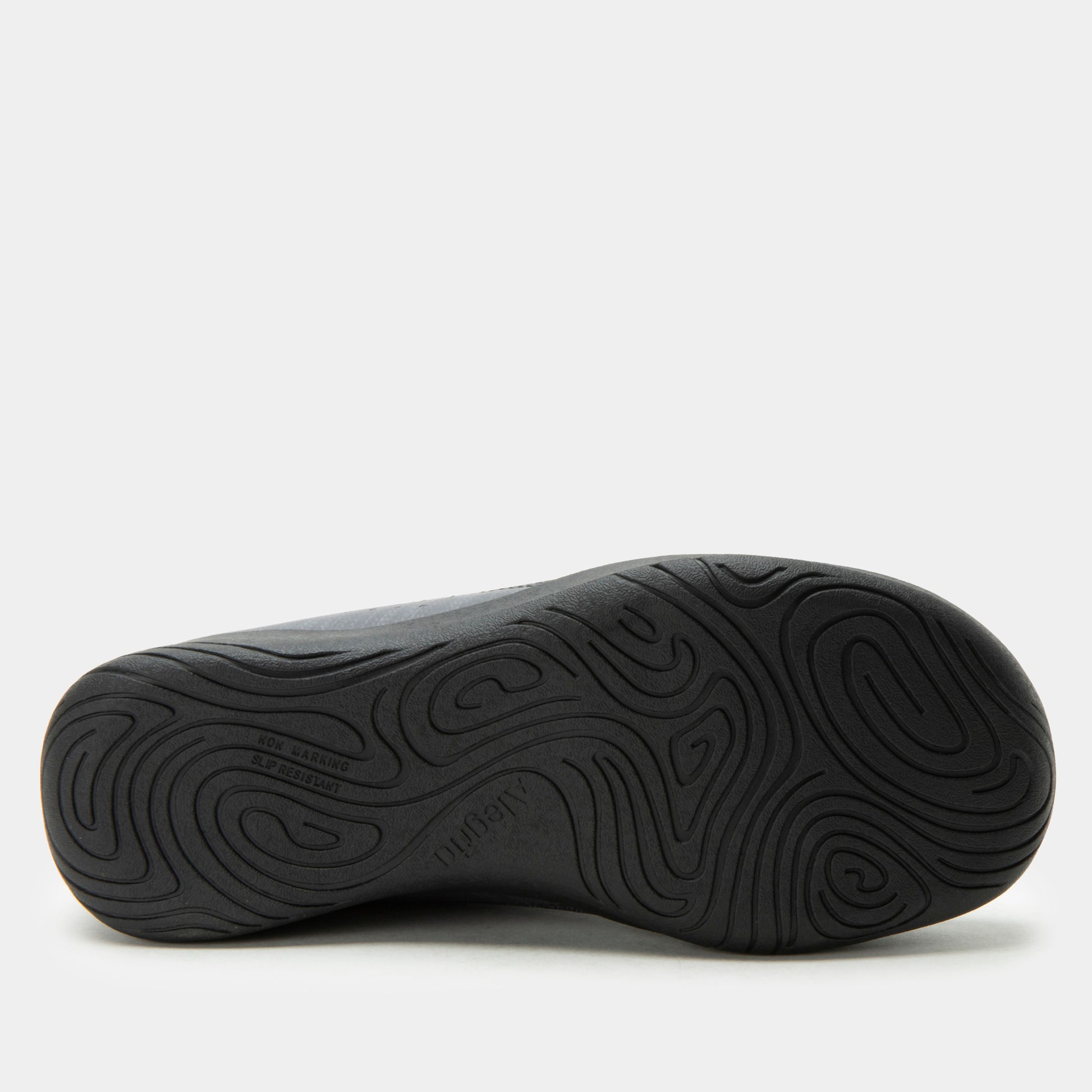 Black shoe sole with wavy tread pattern on a white background