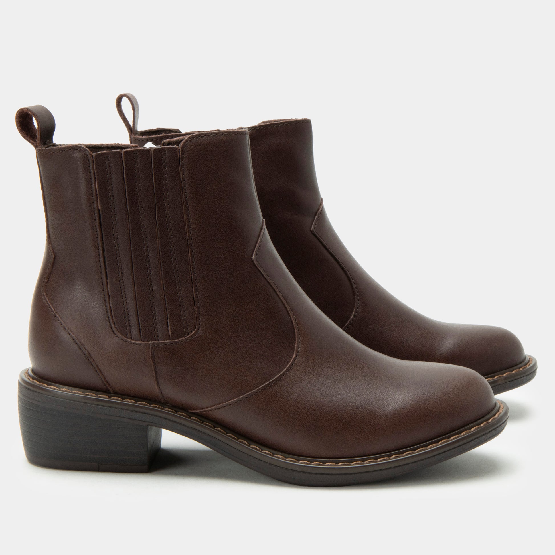 Pair of brown leather boots on a white background