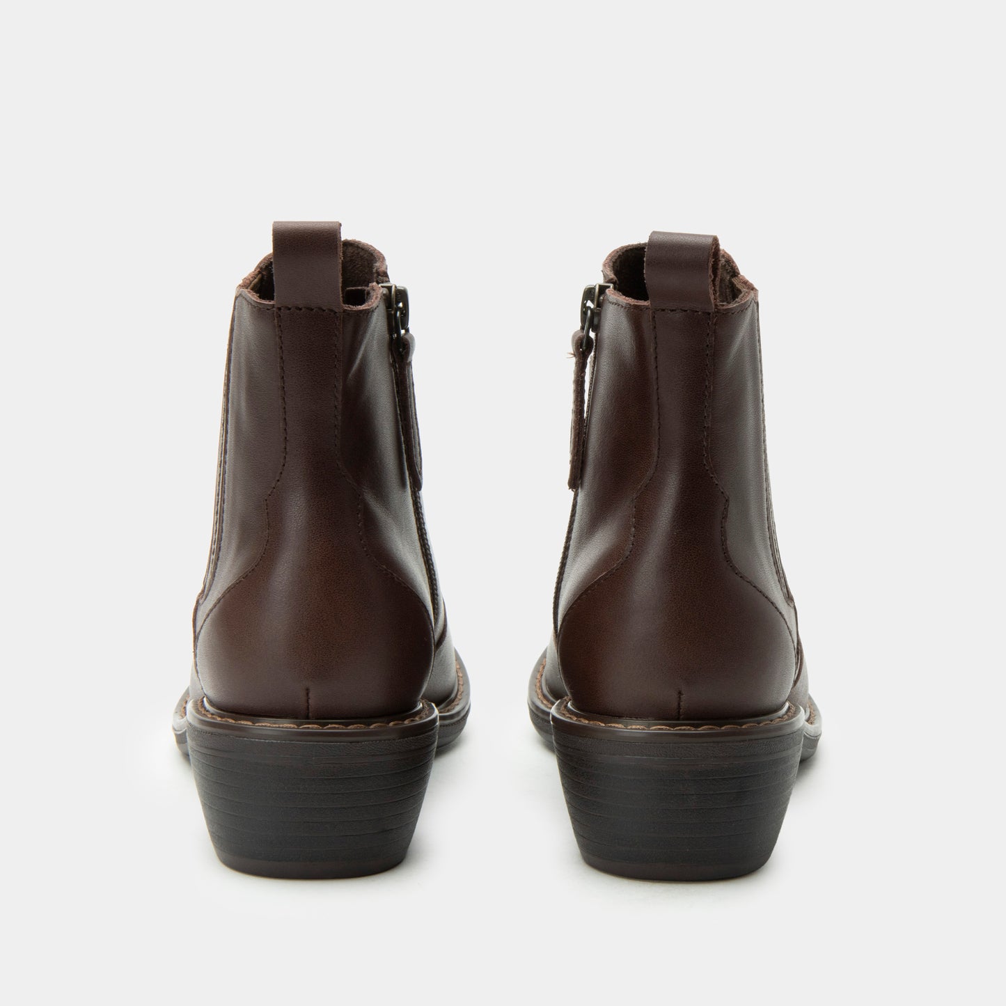 Pair of brown leather boots on a white background