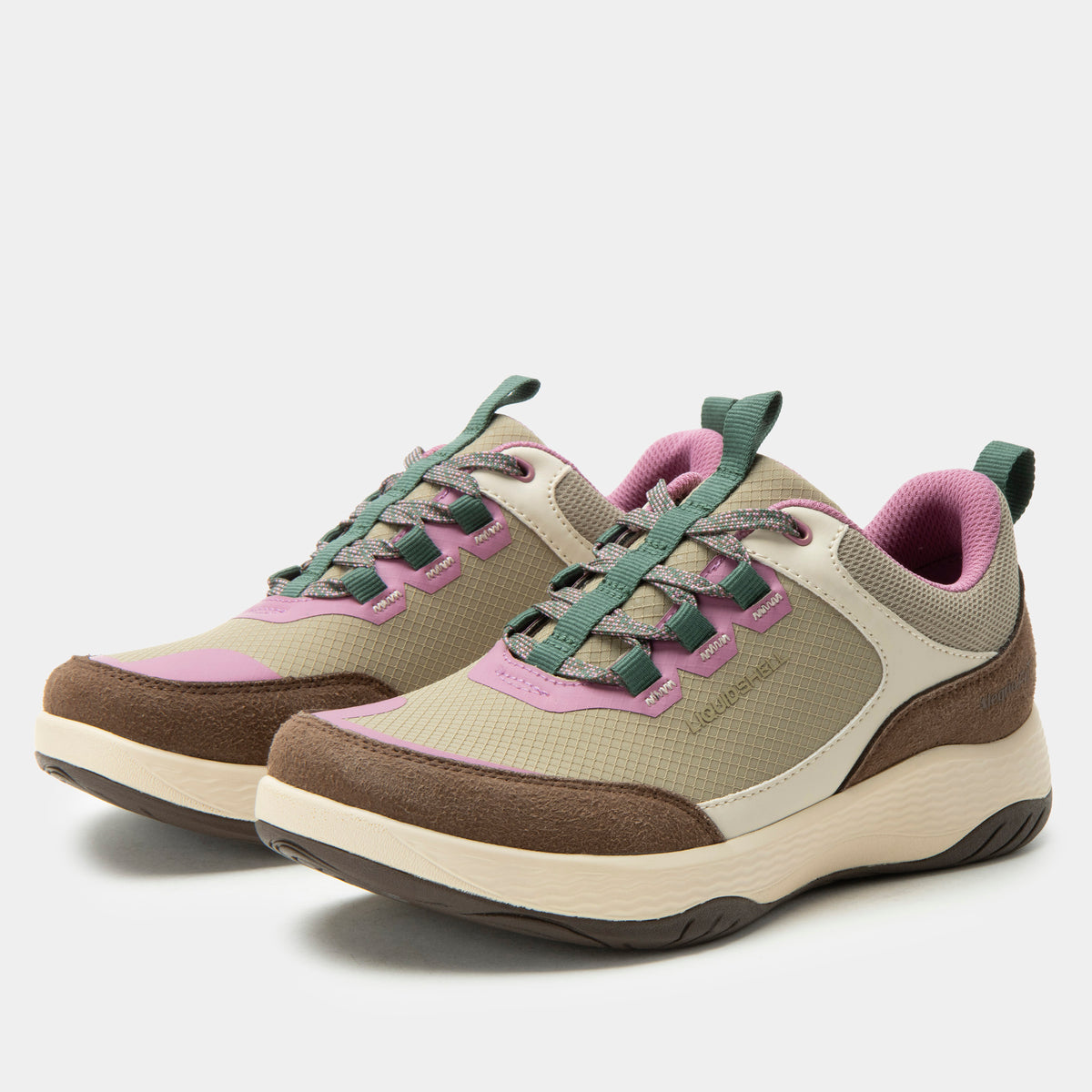 A pair of outdoor sneakers in beige, brown, and green with pink accents, shown on a light gray background.