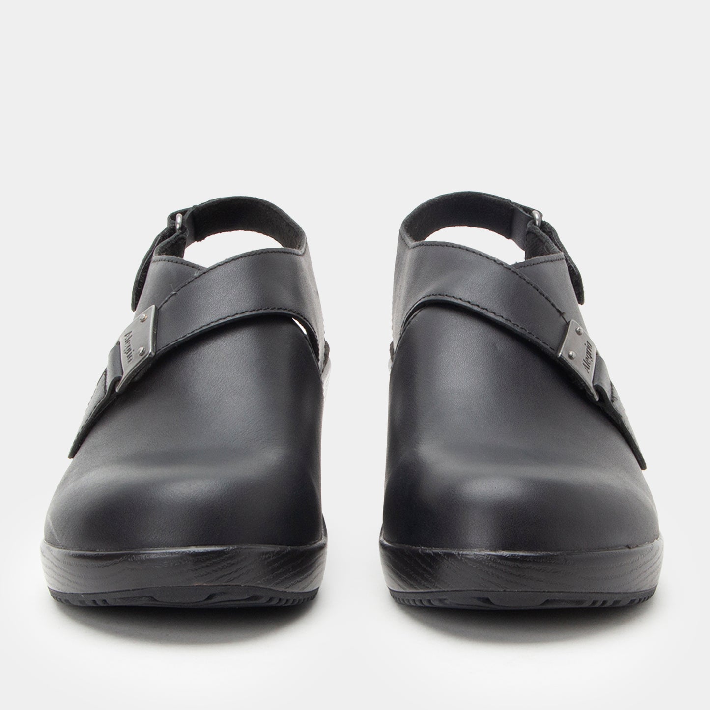 Pair of black clogs on a white background