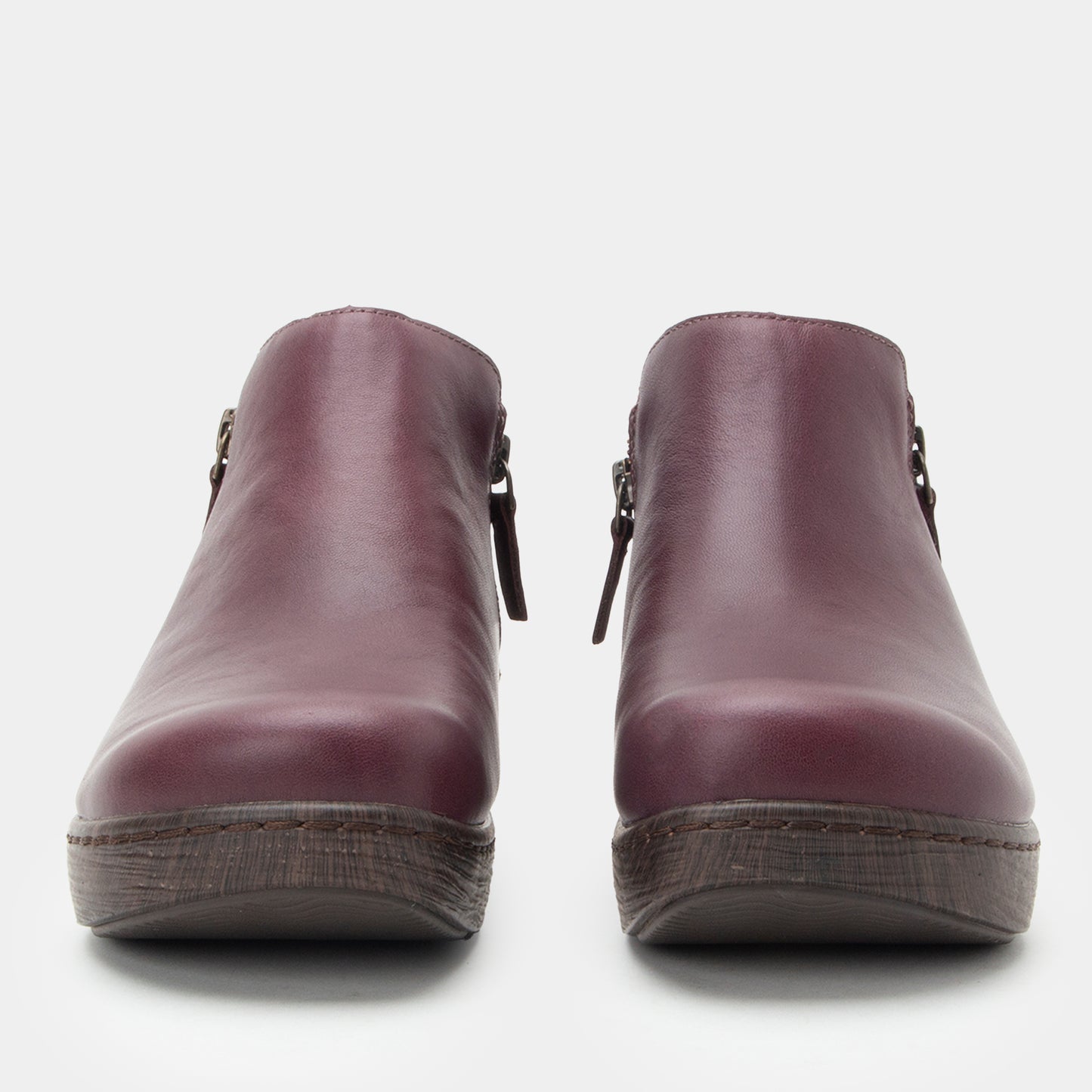 Pair of purple clogs on a white background
