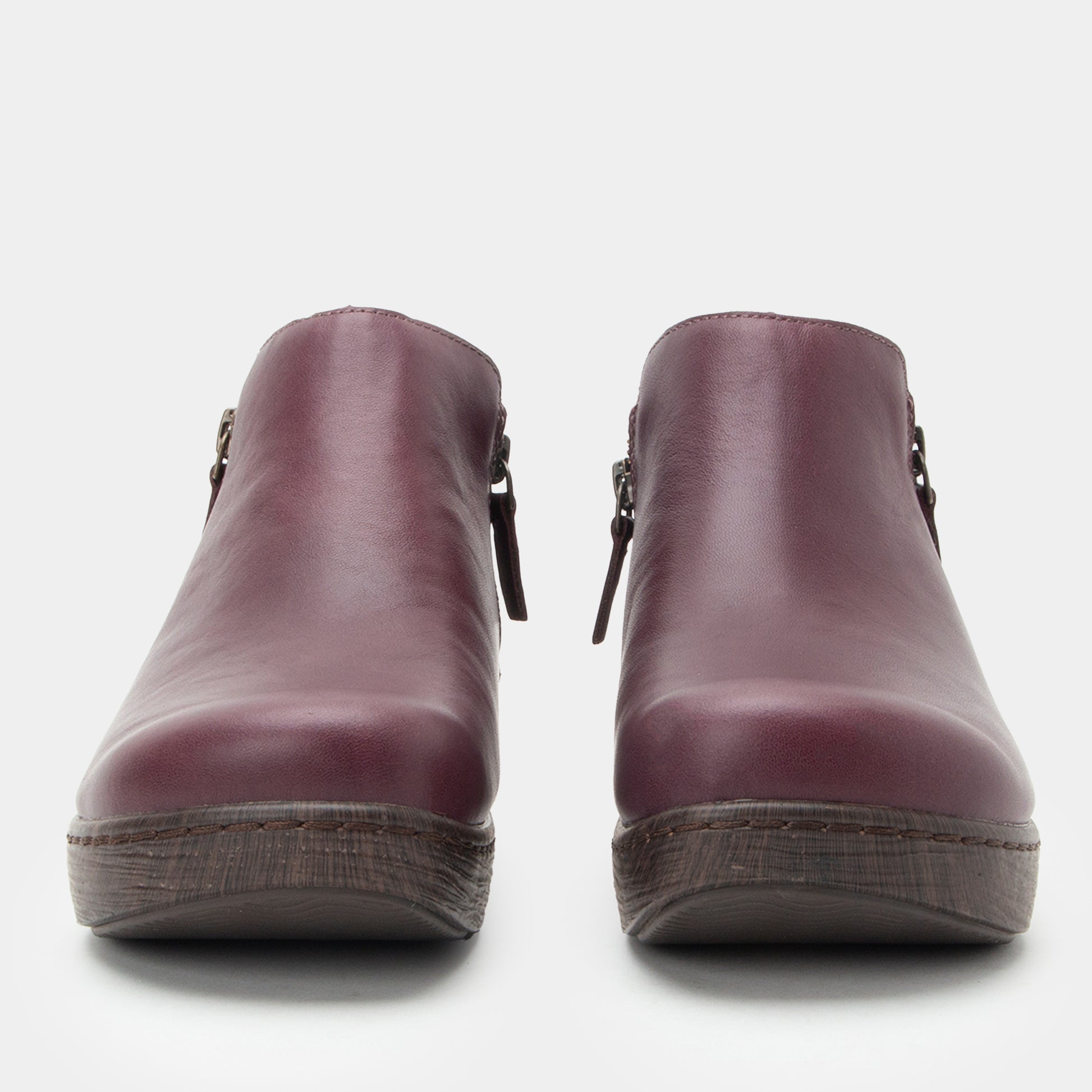 Pair of purple clogs on a white background
