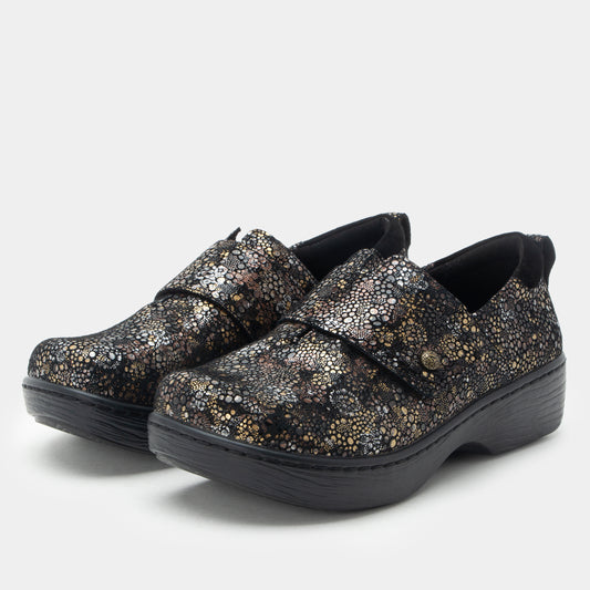 Pair of glittery shoes with black soles on a white background