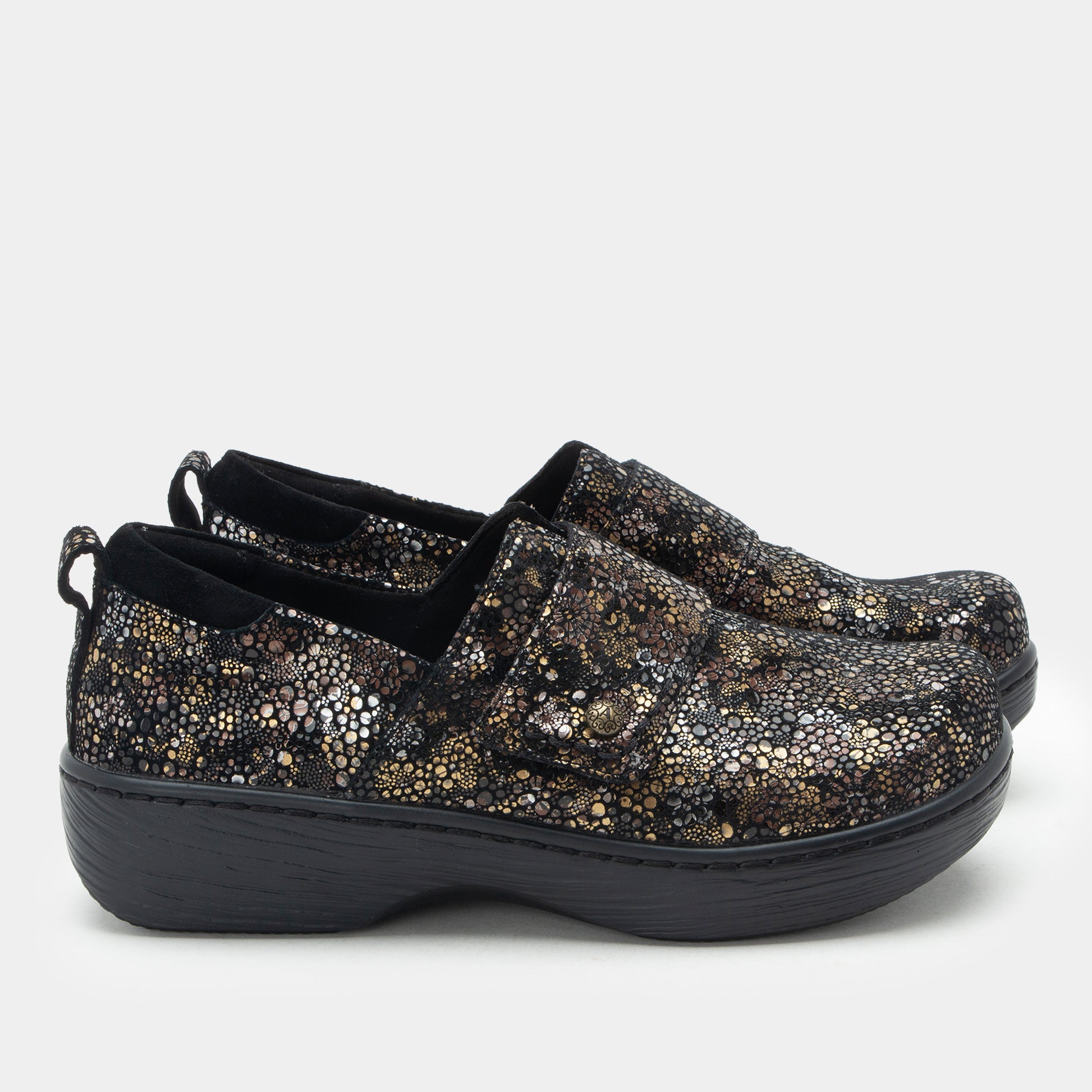Pair of black and gold glittery shoes on a white background