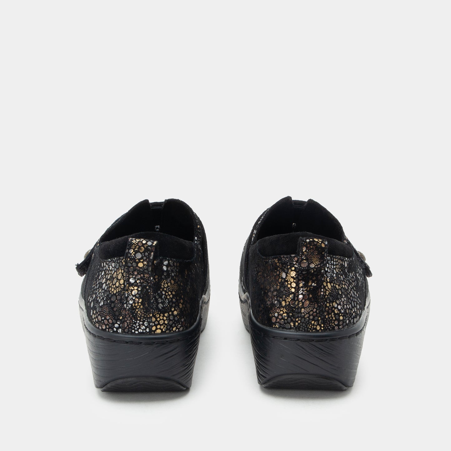 Black slip-on shoes with glittery sole on a white background