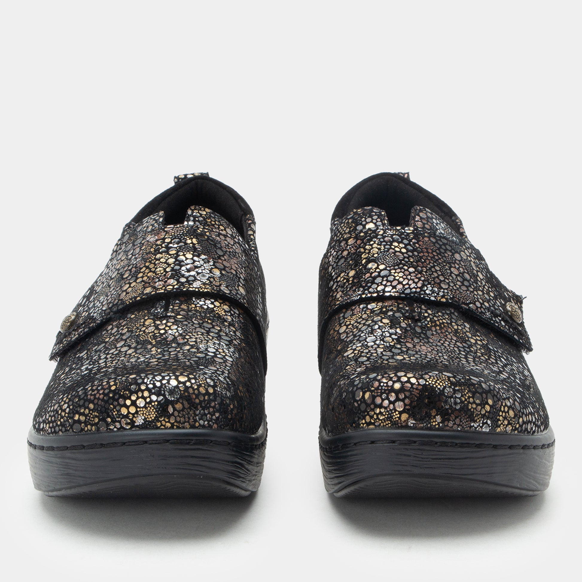 Pair of black and gold patterned shoes on a white background