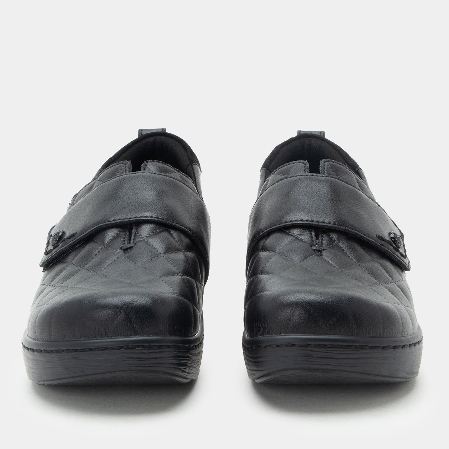 Pair of black shoes with velcro straps on a white background