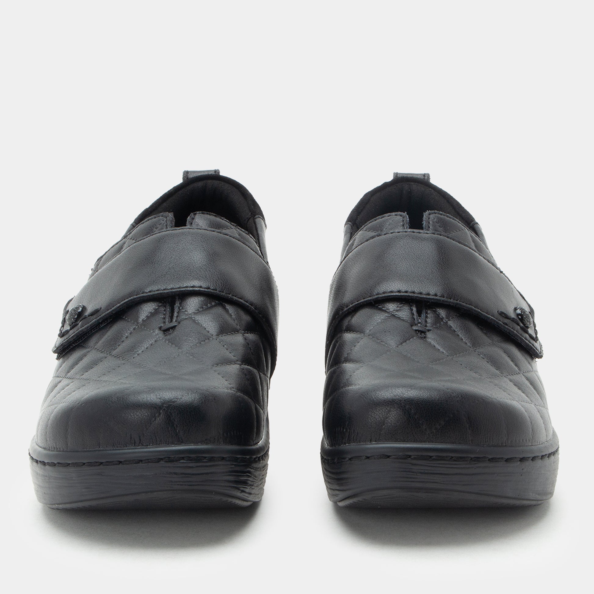 Pair of black shoes with velcro straps on a white background