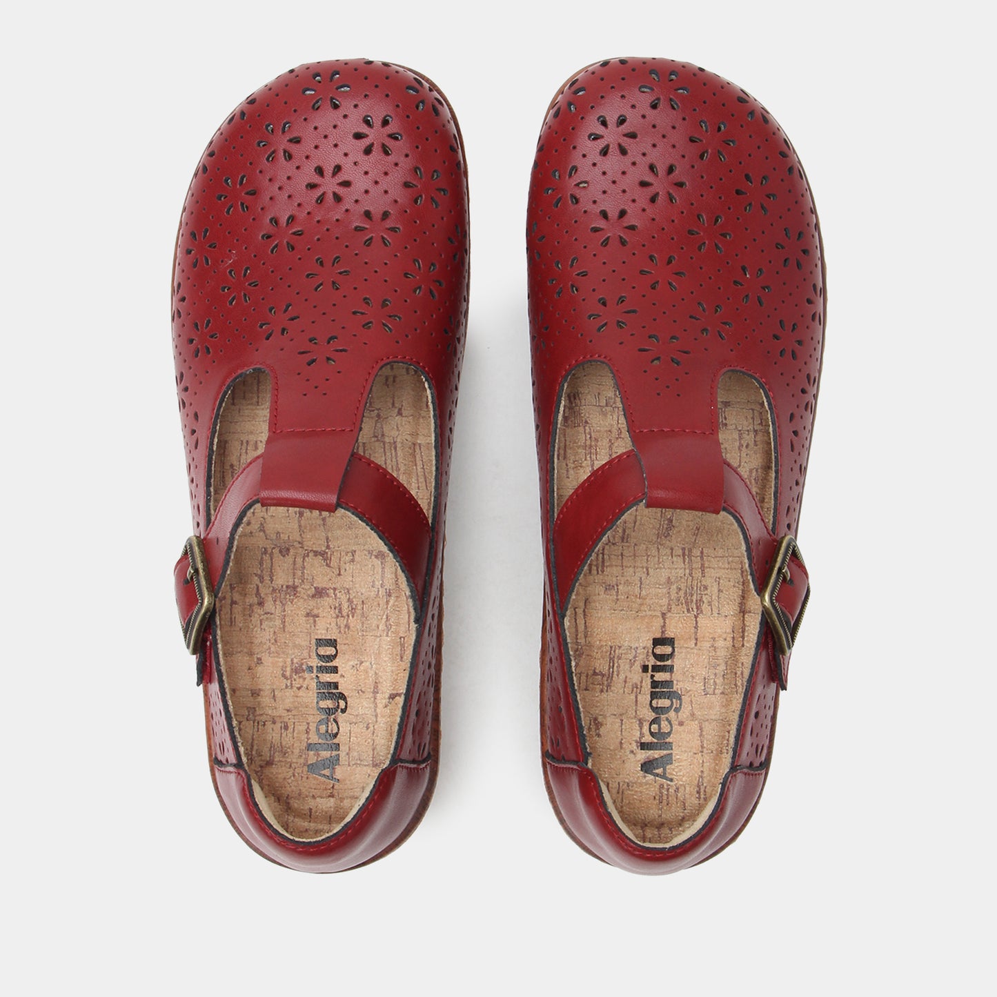 Pair of red clogs with a visible brand name on a white background
