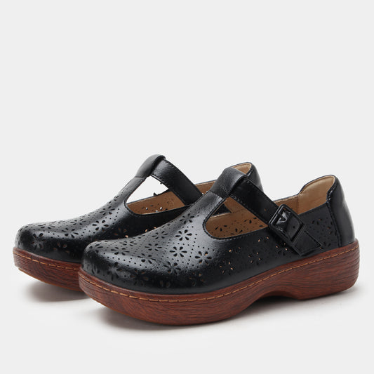 Black leather shoes with brown soles on a white background