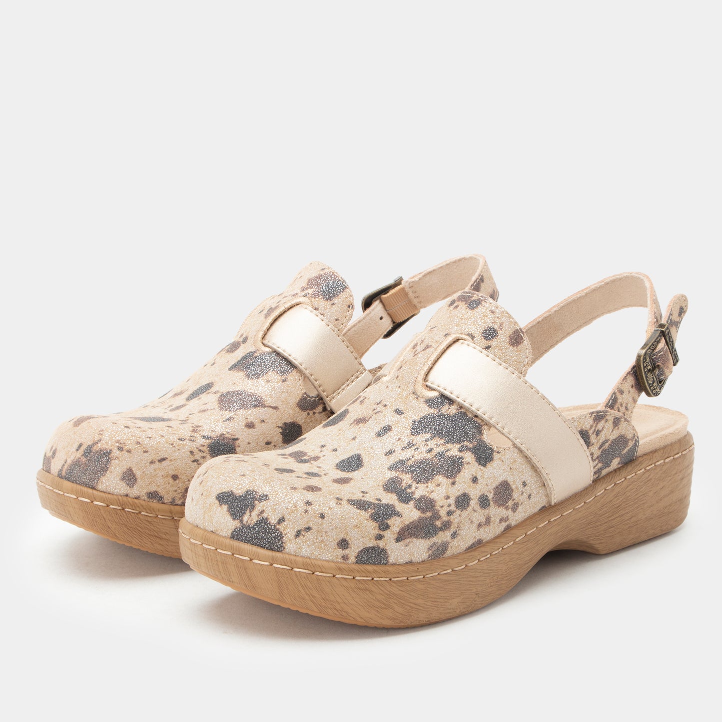 A pair of women's clogs with beige and gray spotted faux-leather uppers, cream straps, and light brown platform soles, shown against a light gray background.