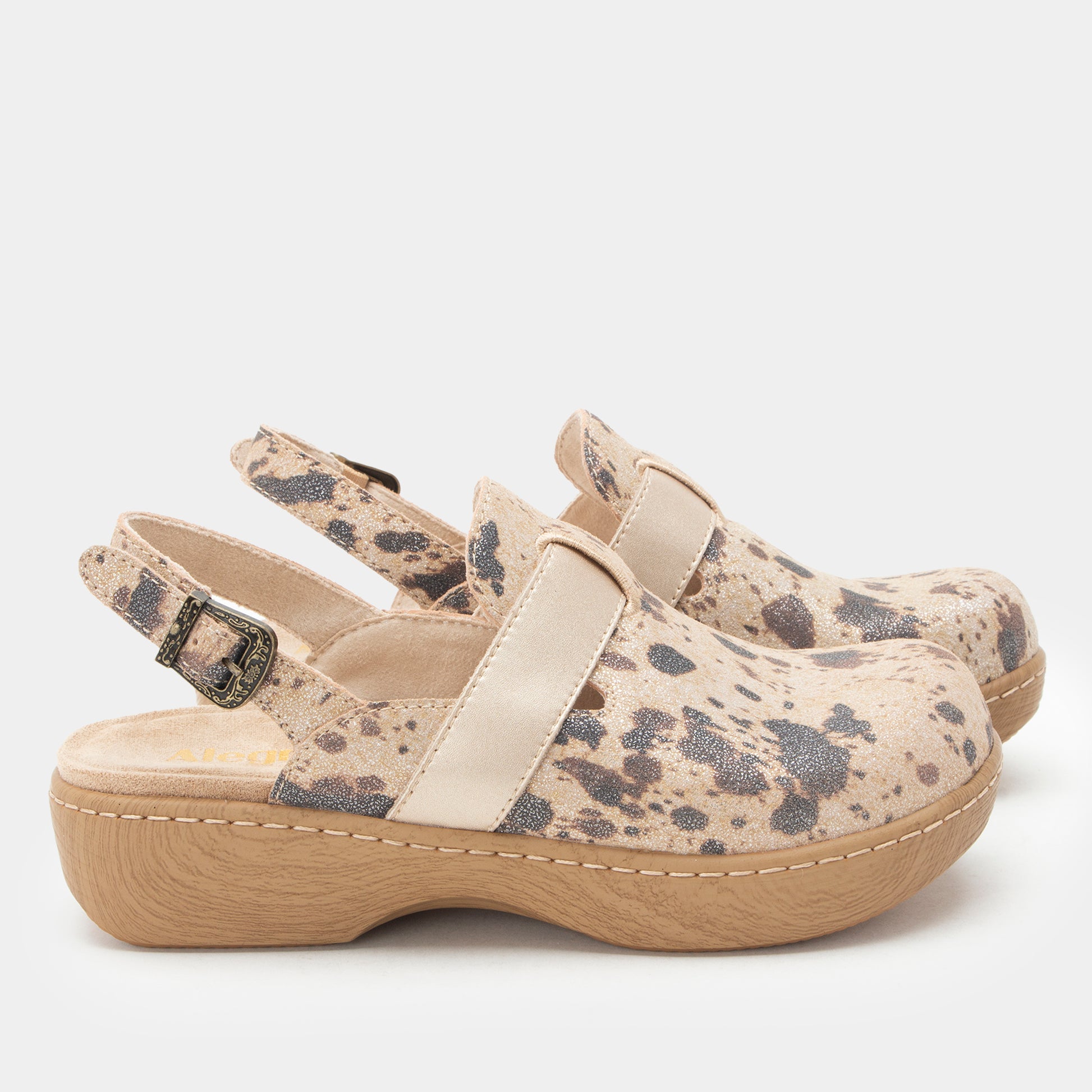 A pair of women's clogs with beige and gray spotted patterned uppers, beige straps, and light brown platform soles, shown against a light gray background.