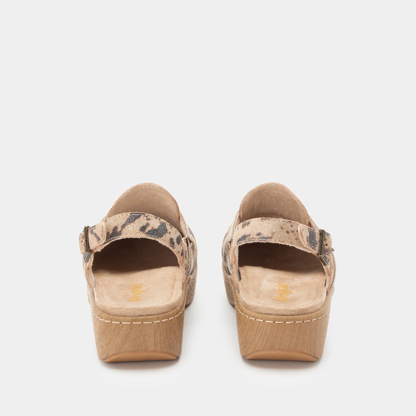 A pair of women's platform mule sandals shown from the back, featuring a beige and brown animal-print strap and a light brown wood-look platform heel, set against a plain light gray background.