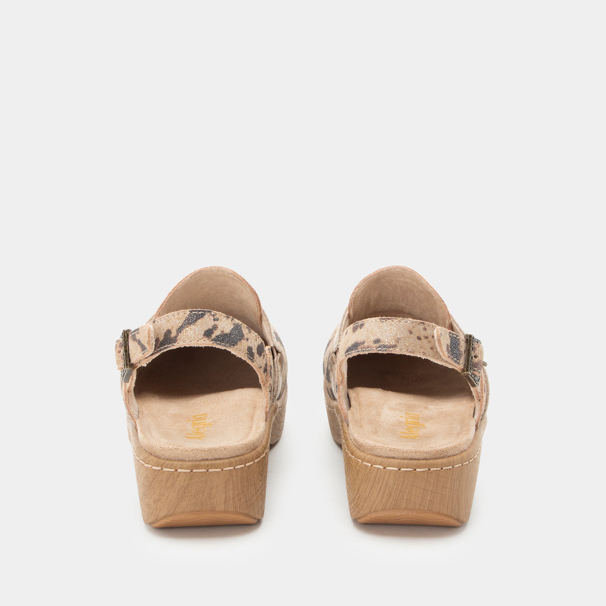 A pair of women's platform mule sandals shown from the back, featuring a beige and brown animal-print strap and a light brown wood-look platform heel, set against a plain light gray background.