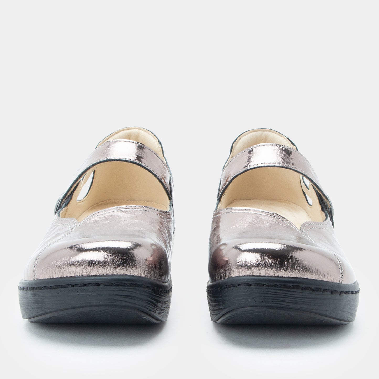 Pair of silver metallic shoes on a white background