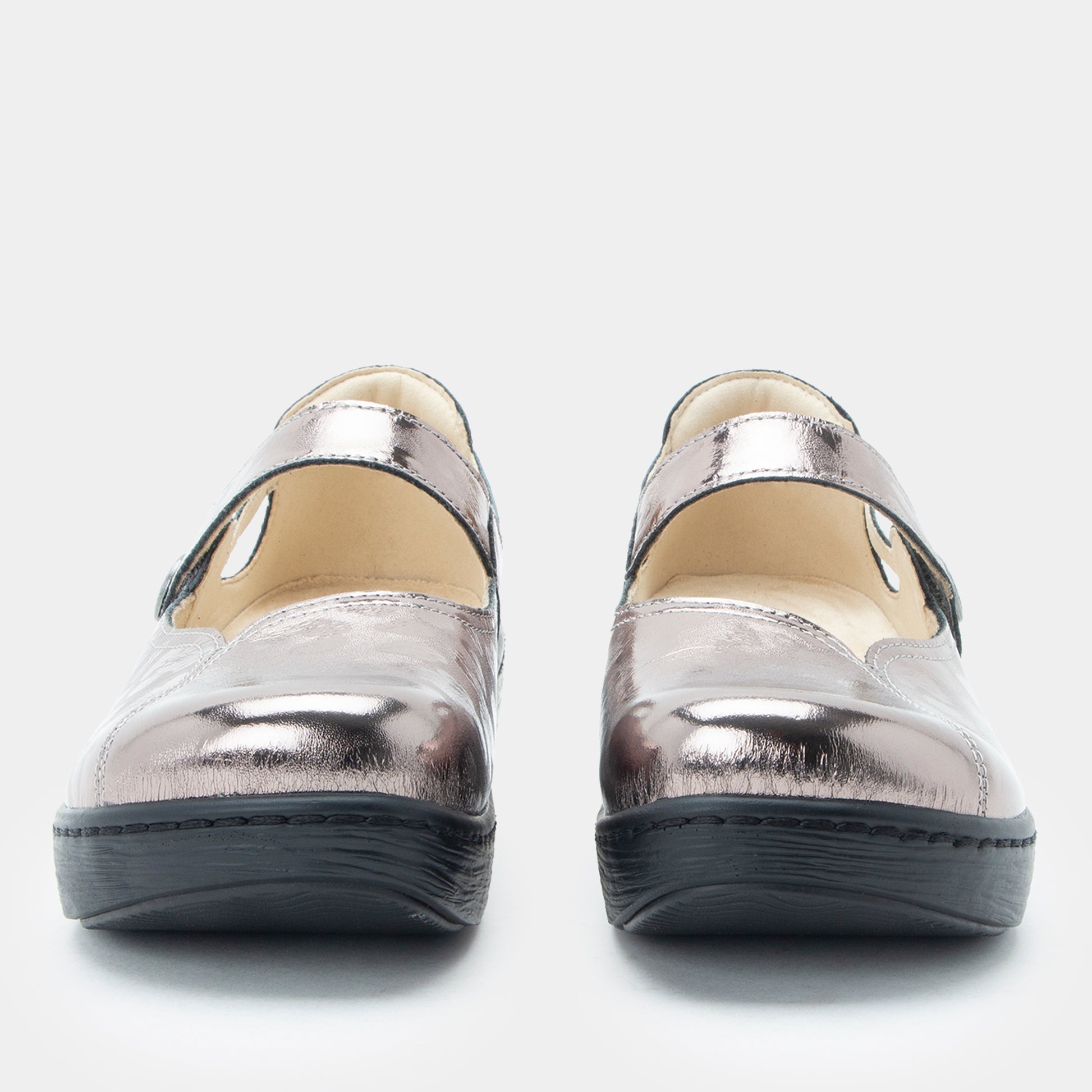 Pair of silver metallic shoes on a white background