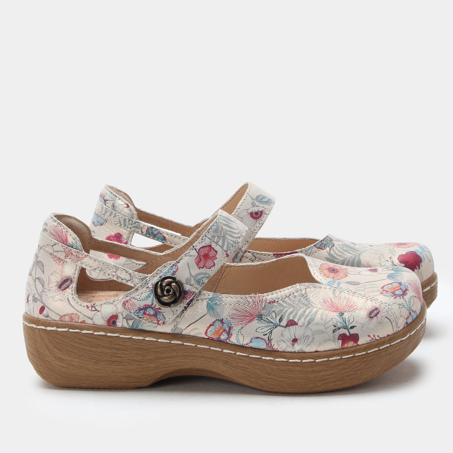 Floral-patterned clogs on a white background