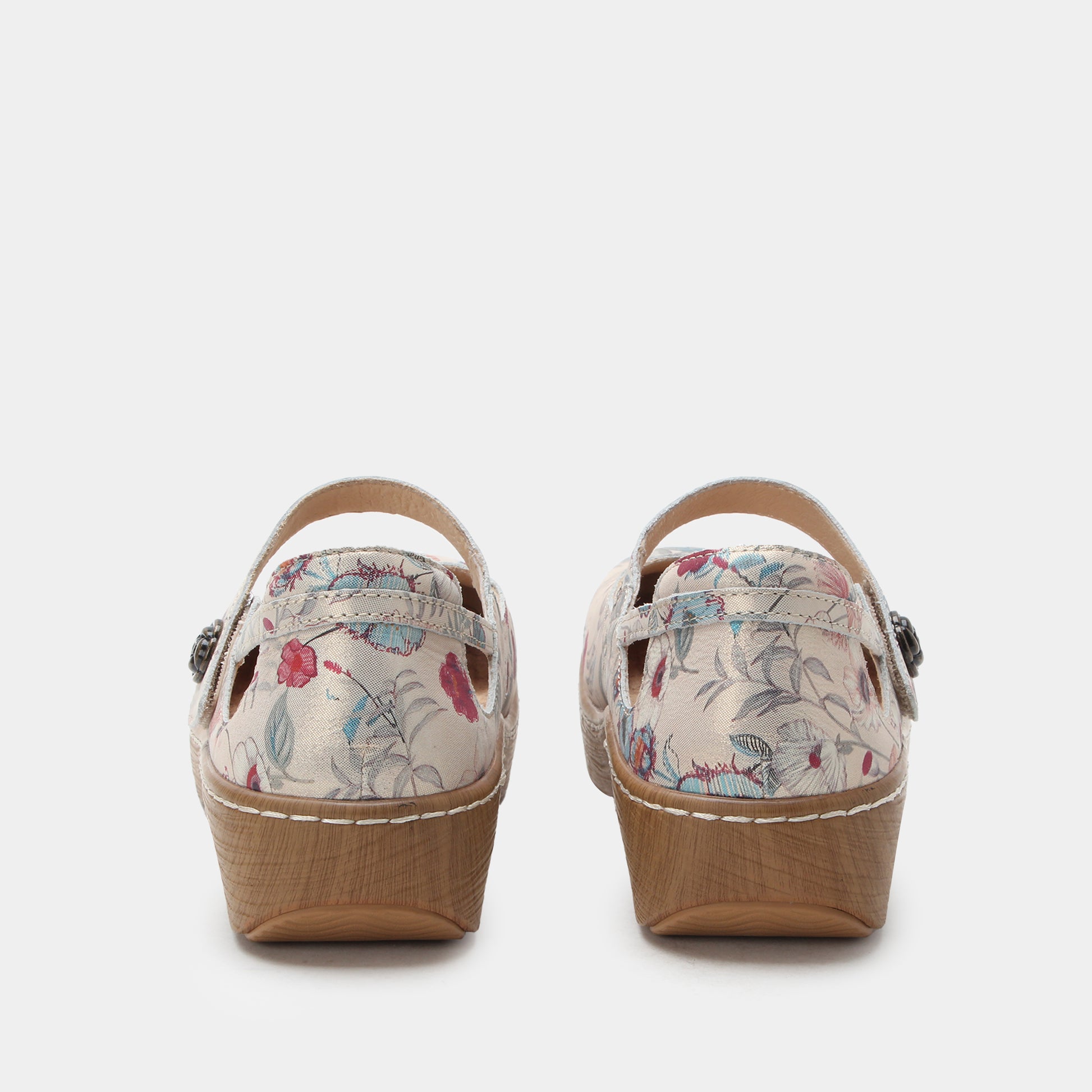 Pair of floral wedge sandals on a white background