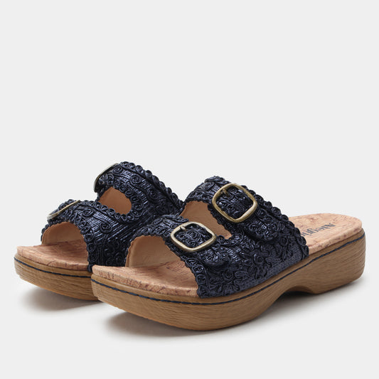 Navy blue sandals with wooden soles on a white background