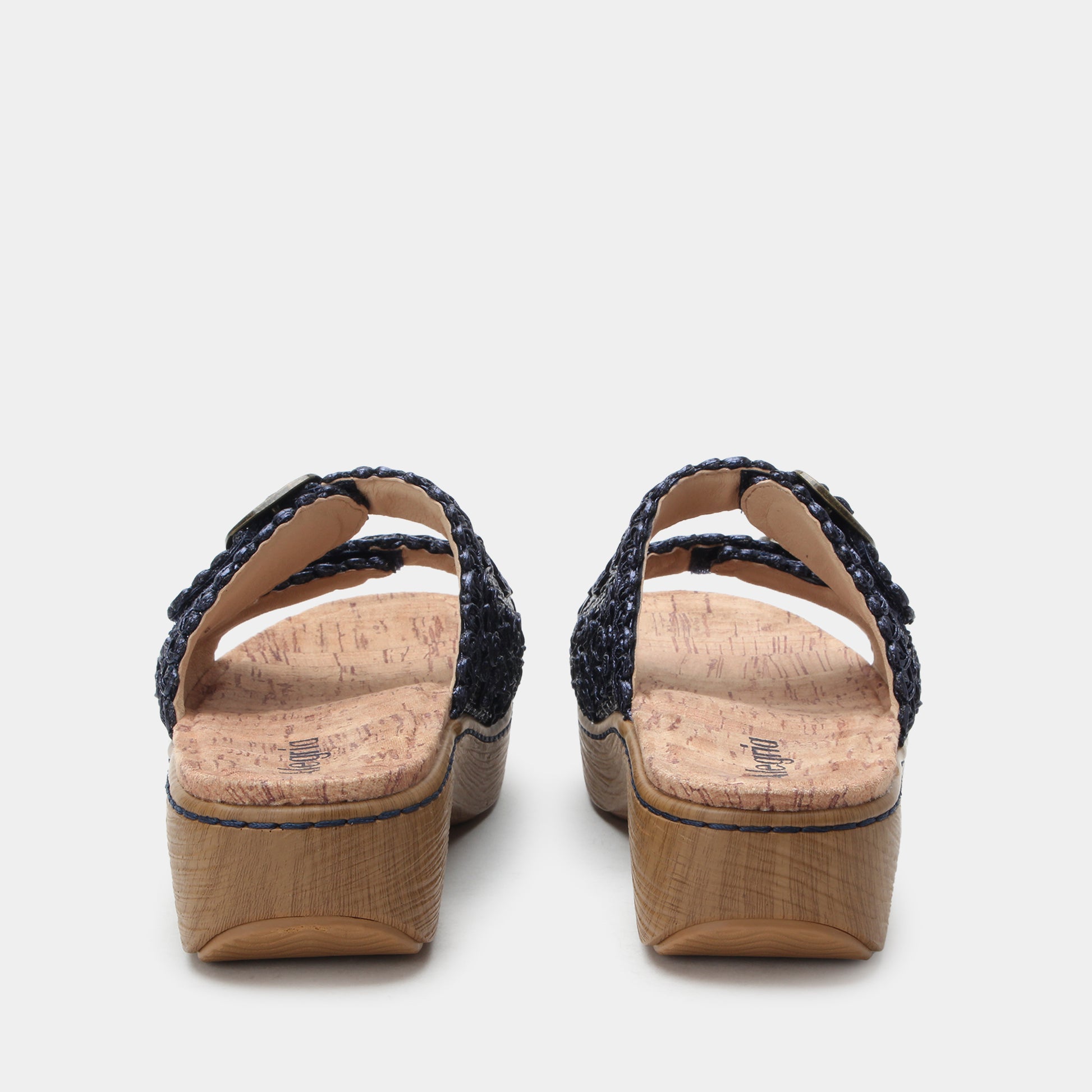 Pair of sandals with cork sole on a light gray background