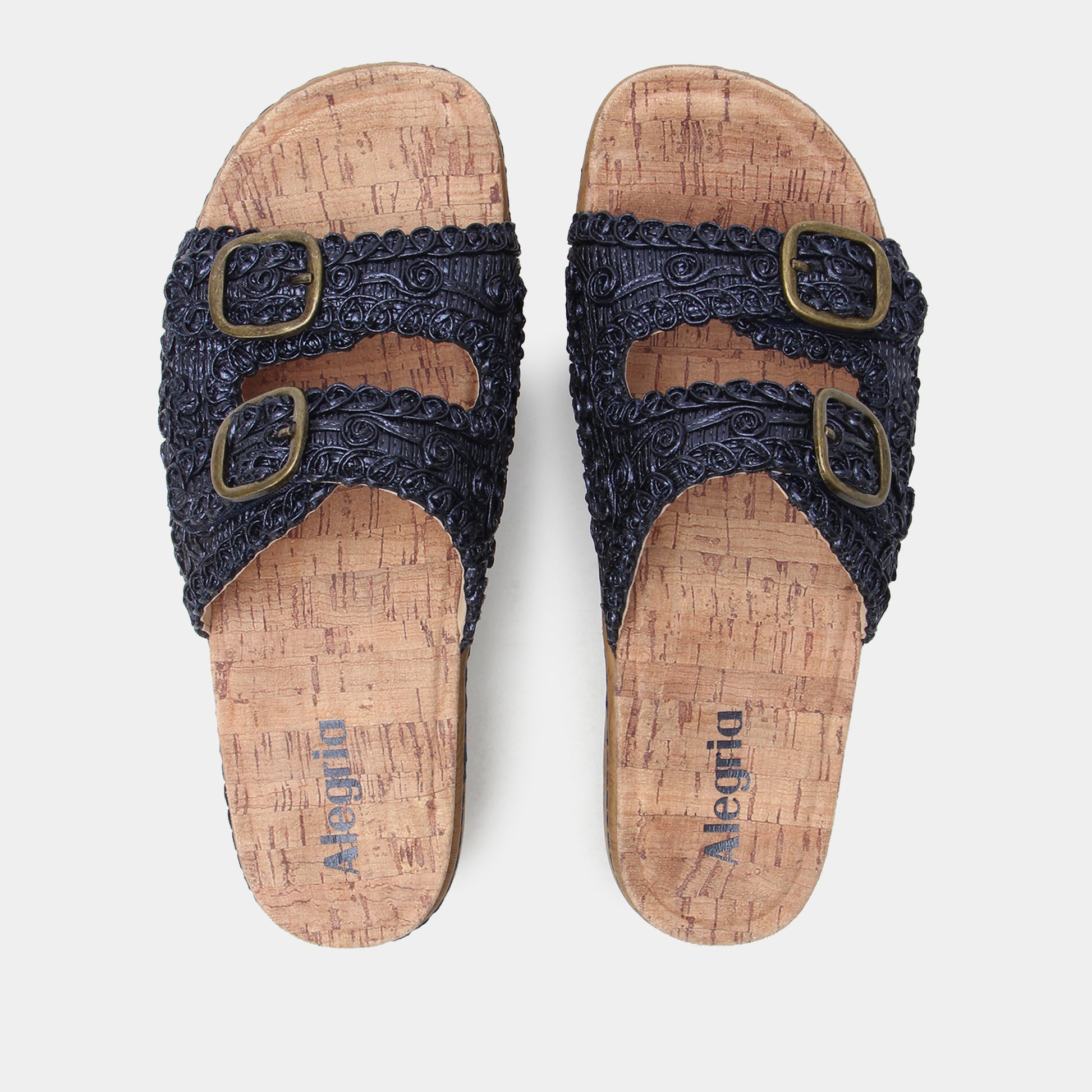 Pair of sandals with cork soles and navy straps on a white background