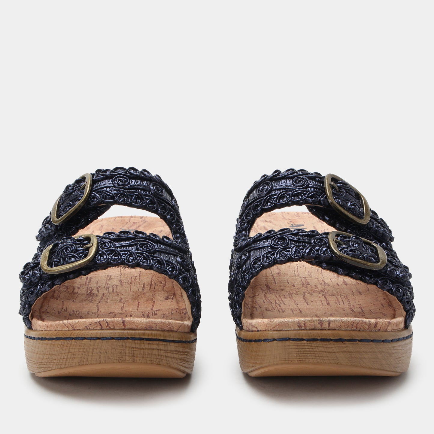 Pair of black sandals with decorative straps on a white background