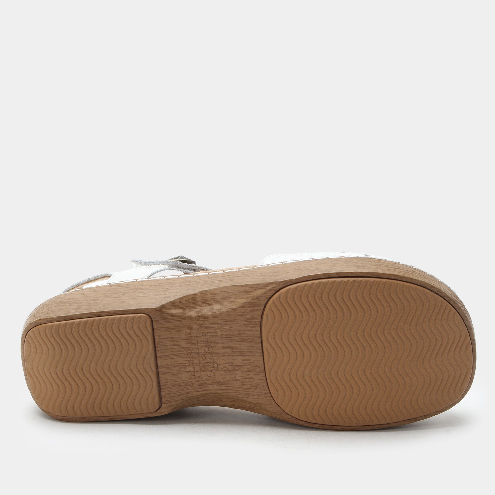 Tan sole of a shoe on a white background