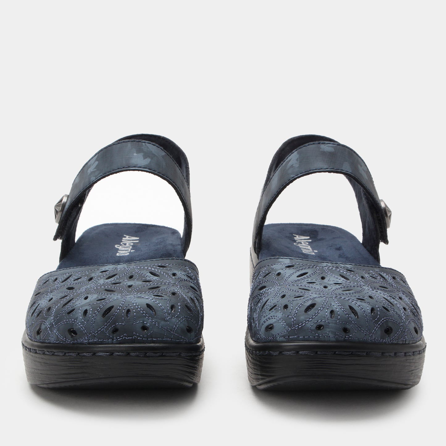 Pair of navy blue sandals with black soles on a white background