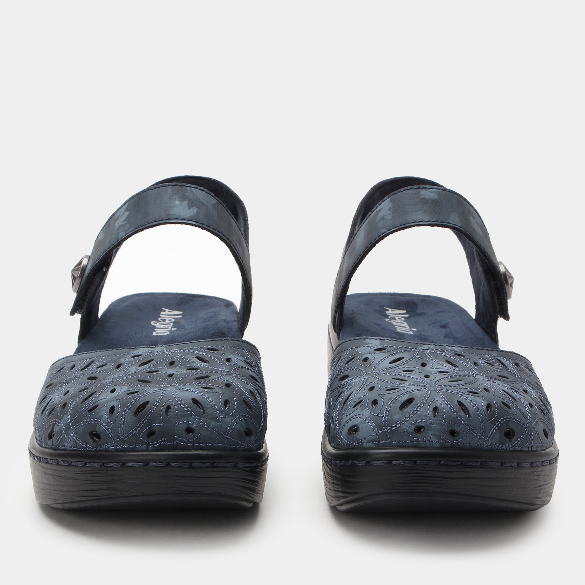 Pair of navy blue sandals with black soles on a white background