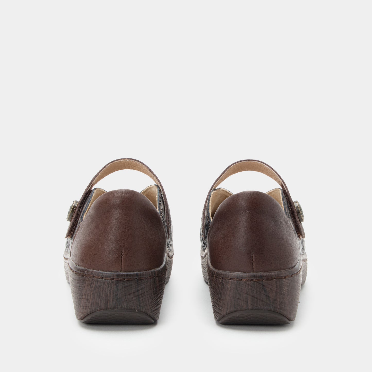 Pair of brown wedge sandals on a white background