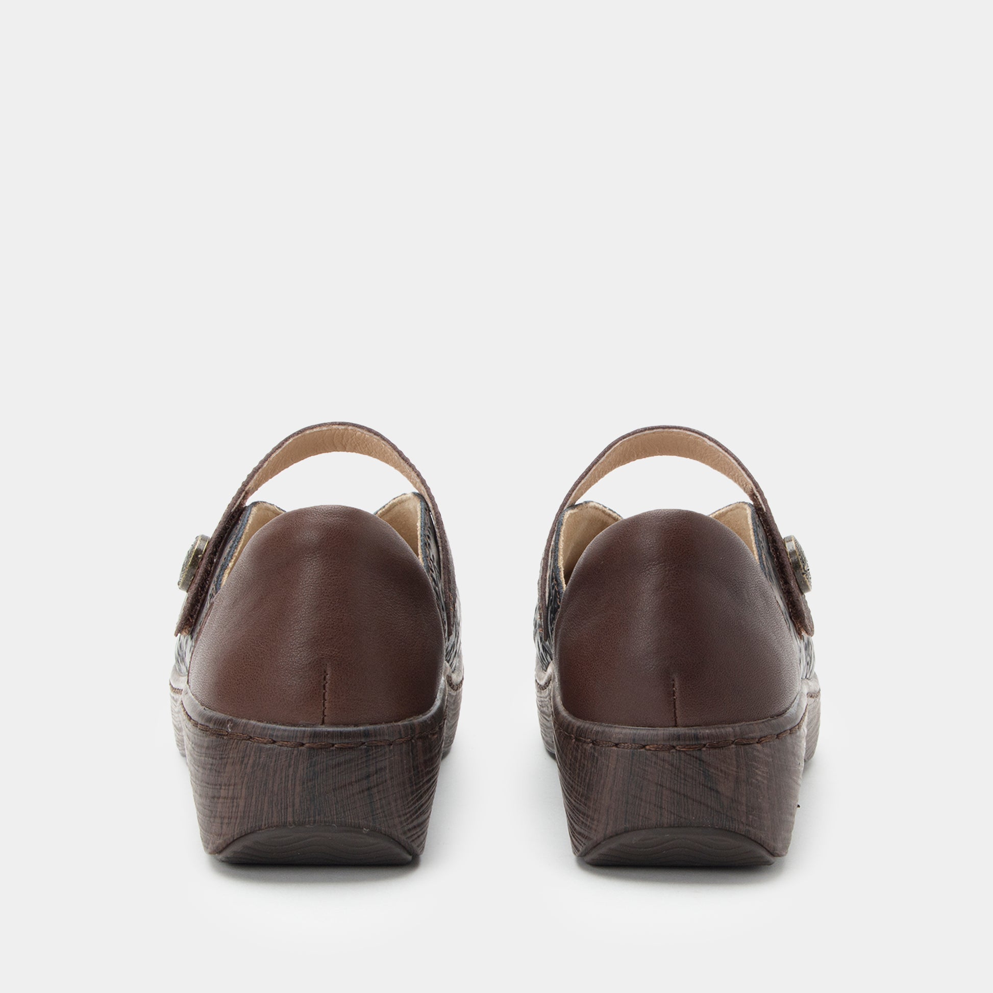Pair of brown wedge sandals on a white background