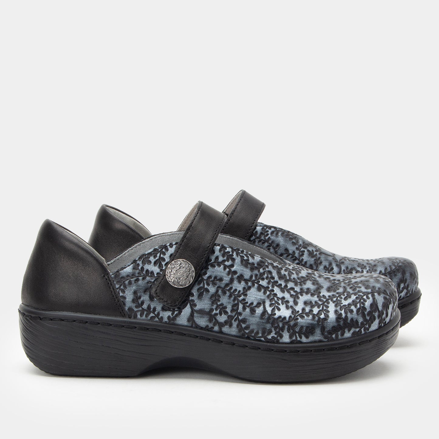 Black and gray floral patterned shoes with a strap on a white background