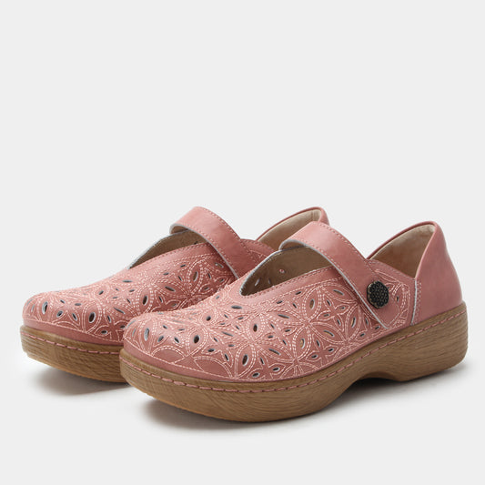 Pair of pink clogs with brown soles on a white background