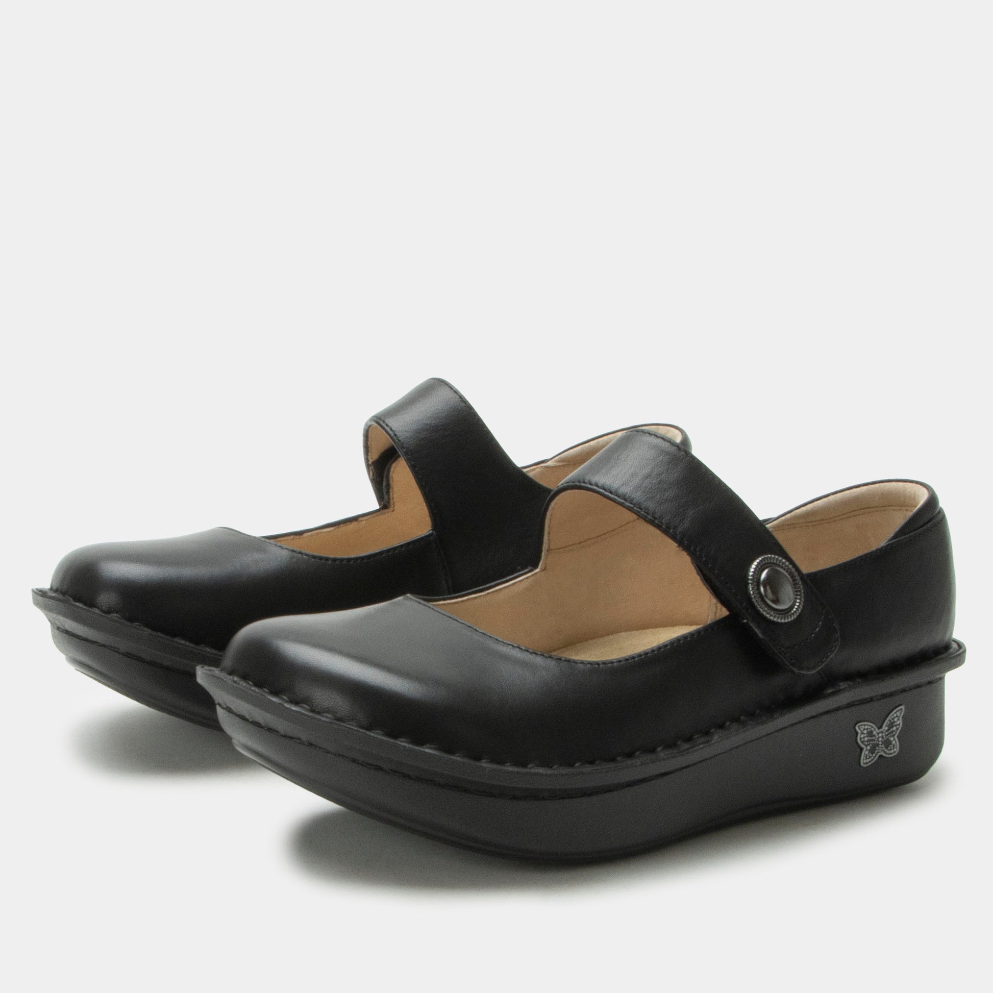 Pair of black shoes with a strap on a white background