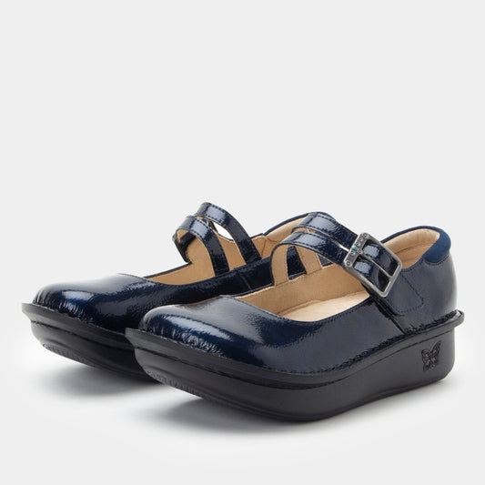 Pair of navy blue shoes with a strap on a white background